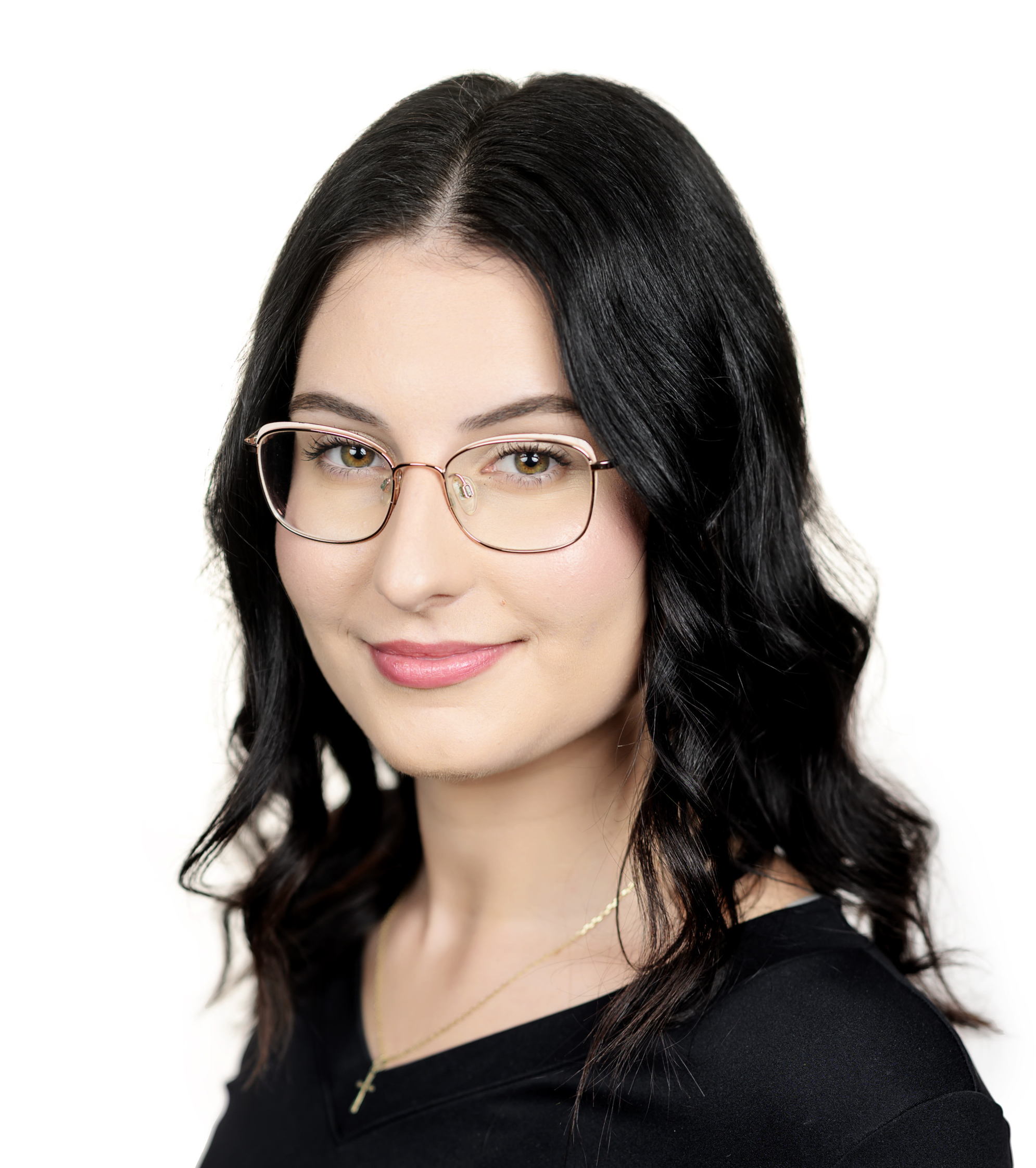 Portrait of a woman with dark hair and glasses, wearing a black top.