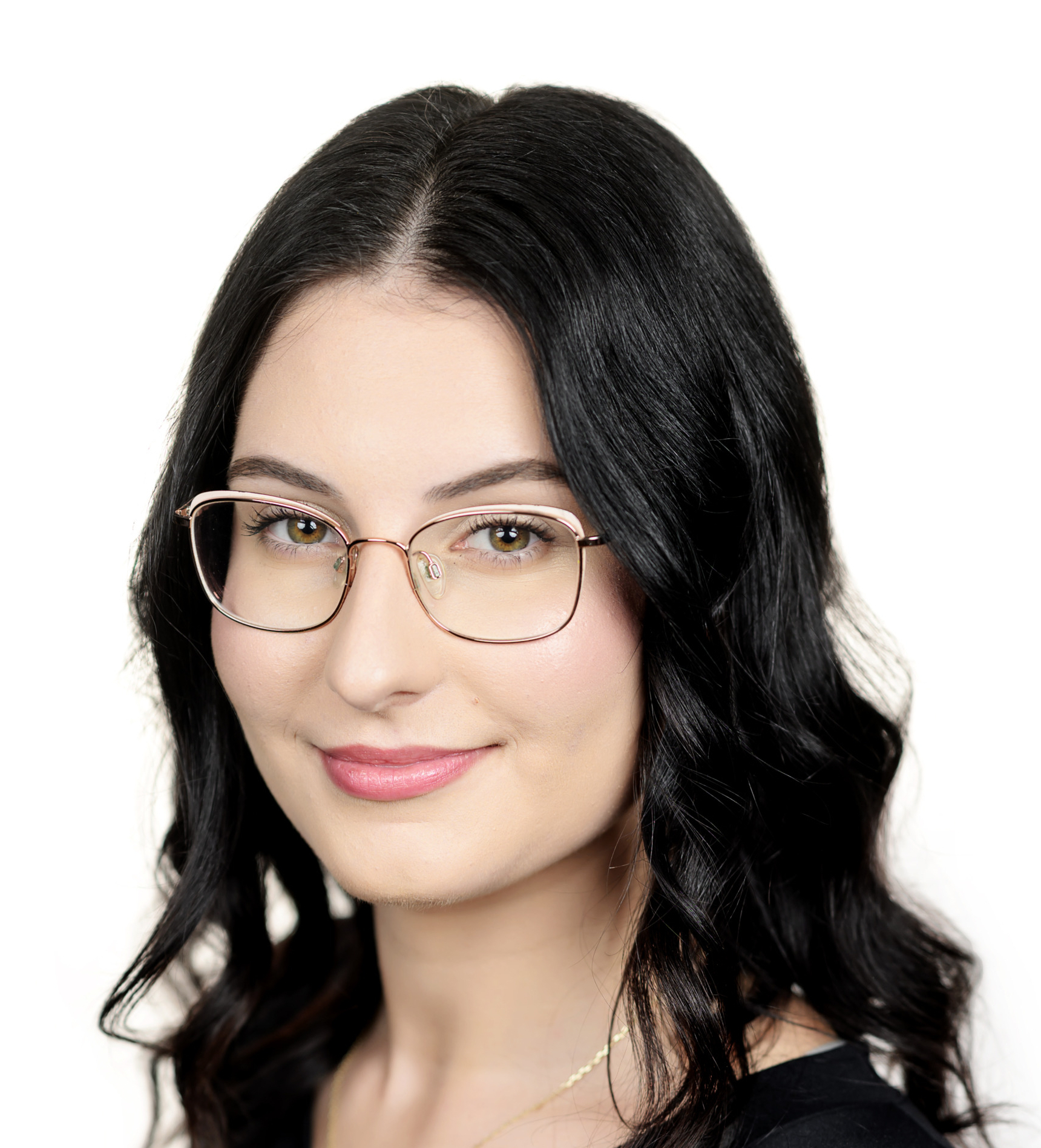 Portrait of a woman with dark hair and glasses, wearing a black top.